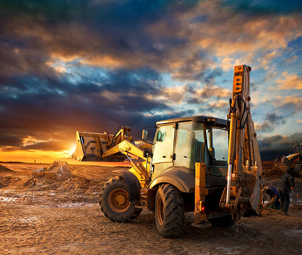 Construction equipment at sunset